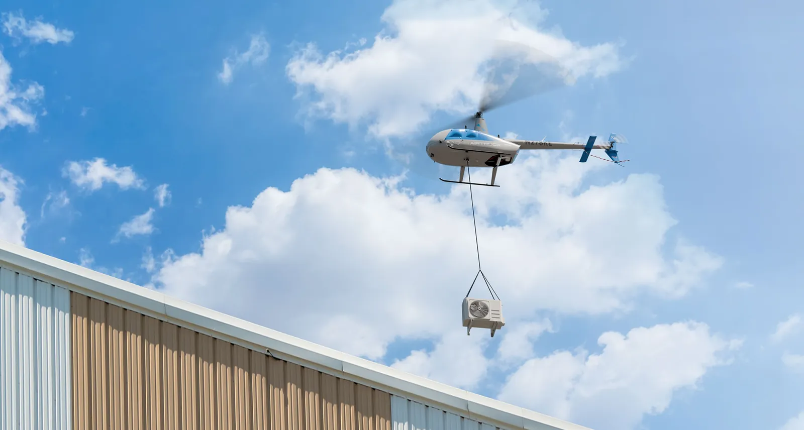 Robinson R44 Airtruck unmanned helicopter carrying a sling load