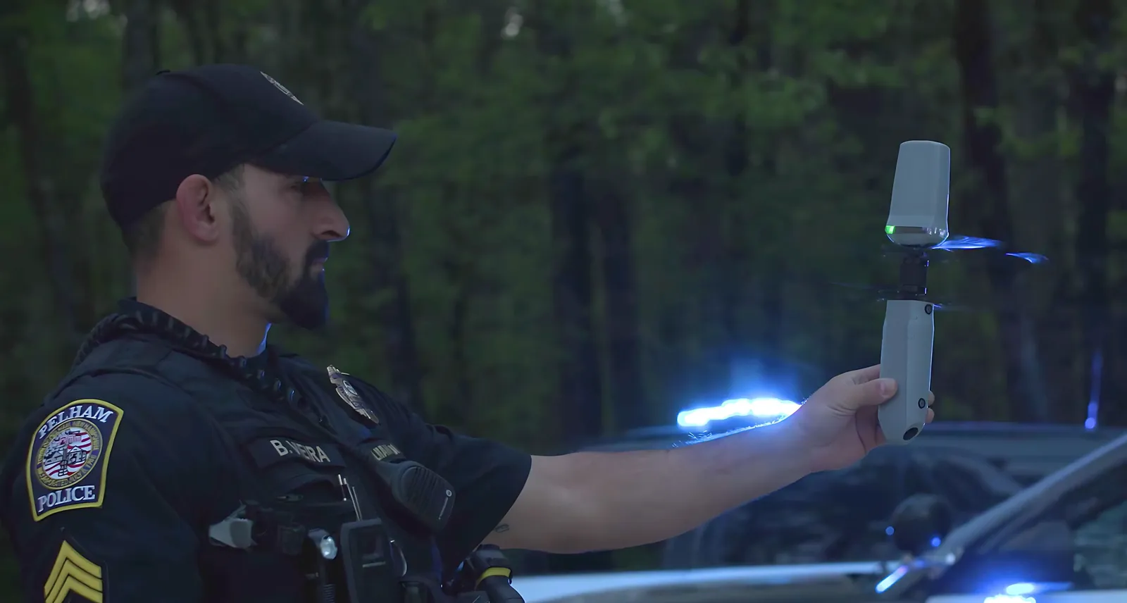 Police officer launching a Robinson Unmanned Helius drone by hand
