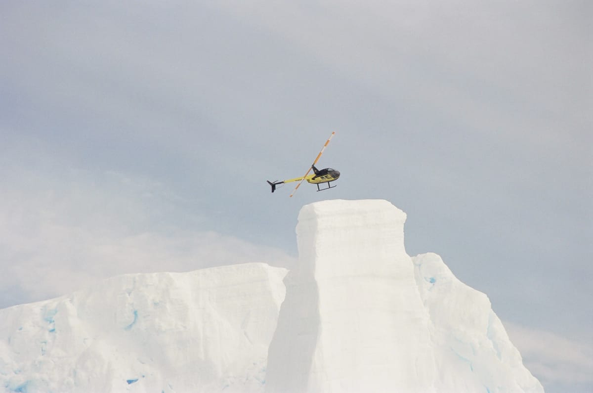 Helicopter over an Antarctic iceberg