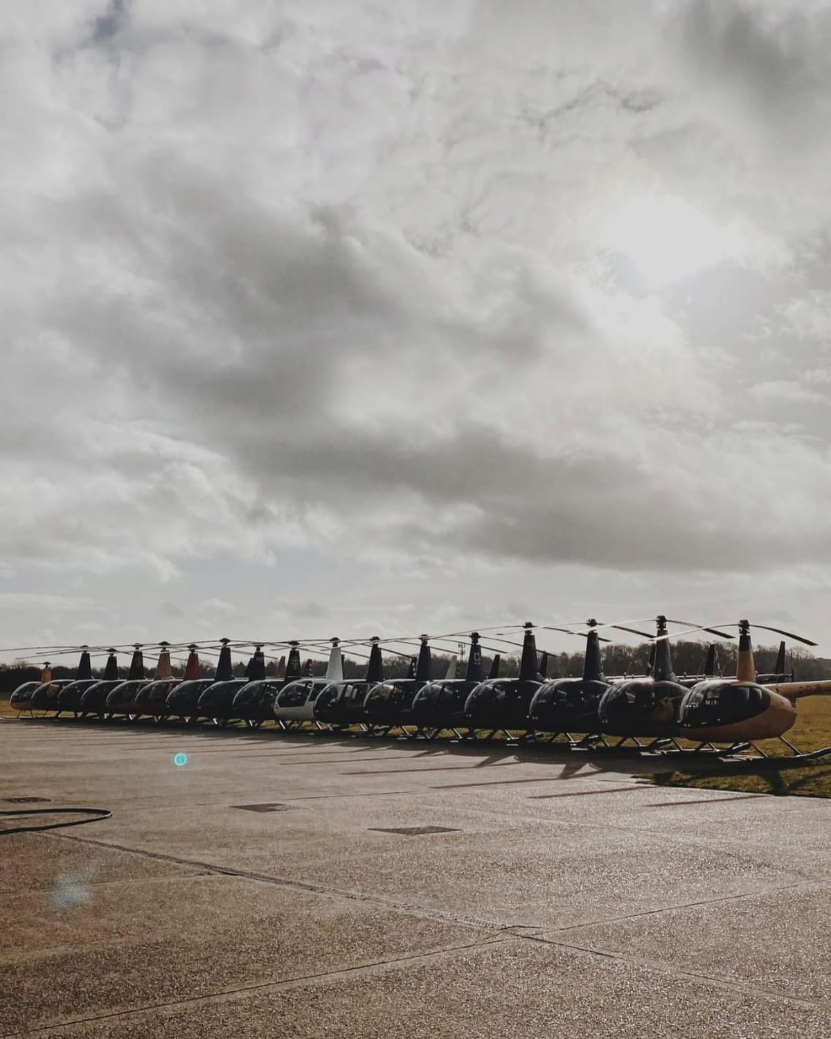 HQ Aviation Robinson training fleet lined up at Denham