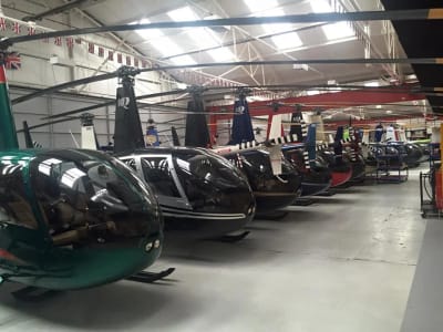 Robinson helicopters parked inside the shared hangar at Denham Aerodrome