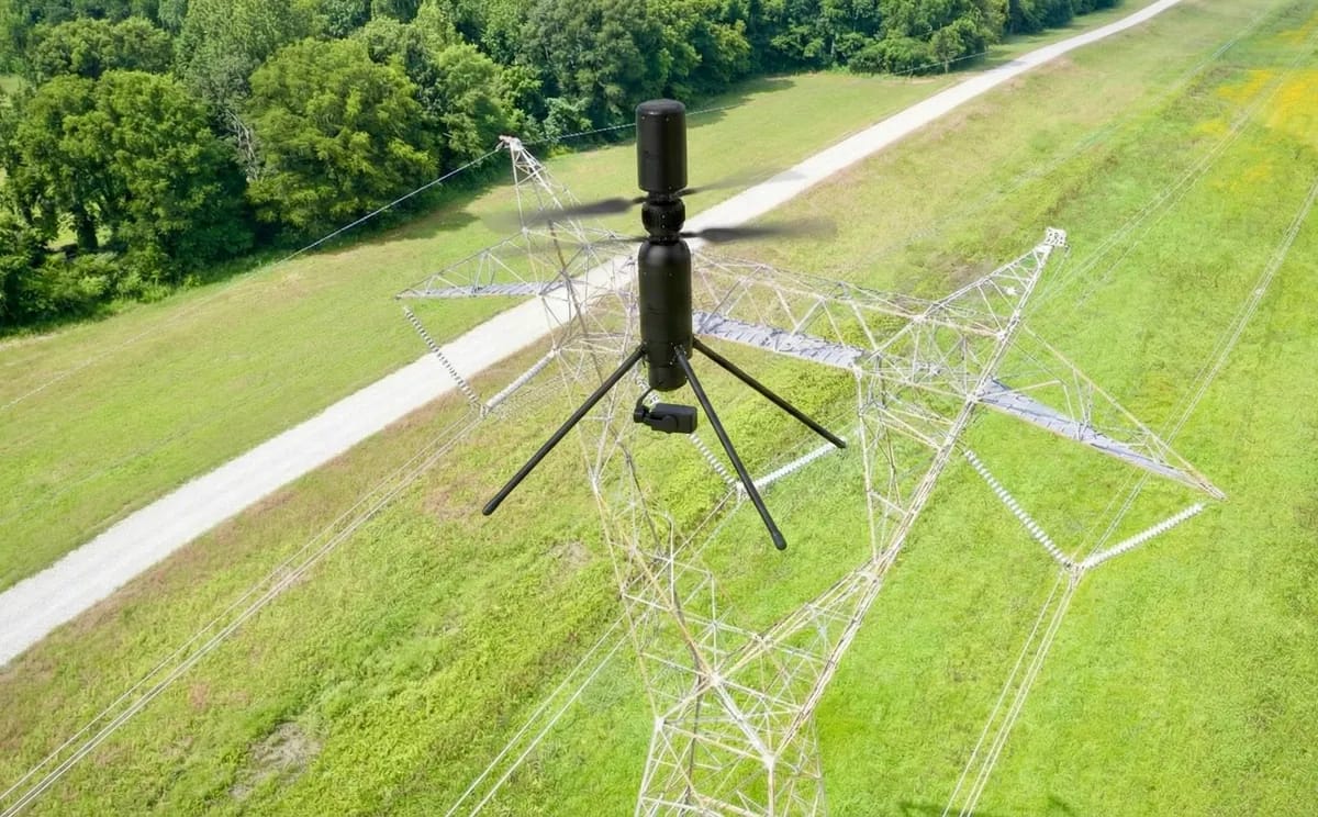 Robinson Unmanned Spirit drone hovering beside a power line pylon